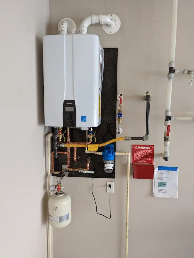 Professional plumber installing copper piping in a Covington home